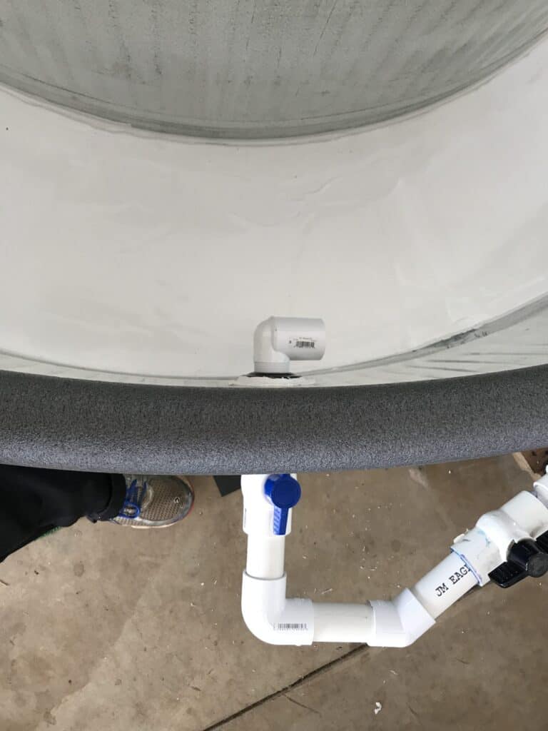 The inlet fitting positioned to control water current direction in the tank, view 1.
